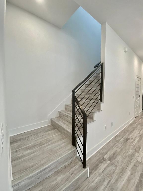 6809 Montana Street, Unit 2 Austin, TX 78741 - Photo 14 of 29 a view of a hallway with stairs and wooden floor