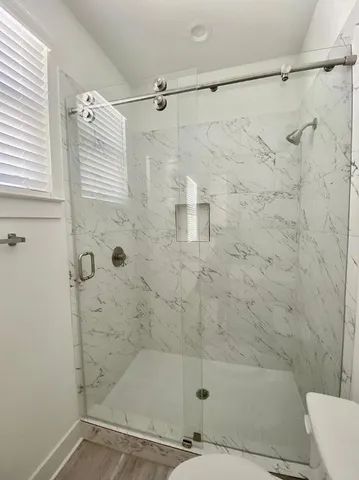 a bathroom with a shower and a toilet