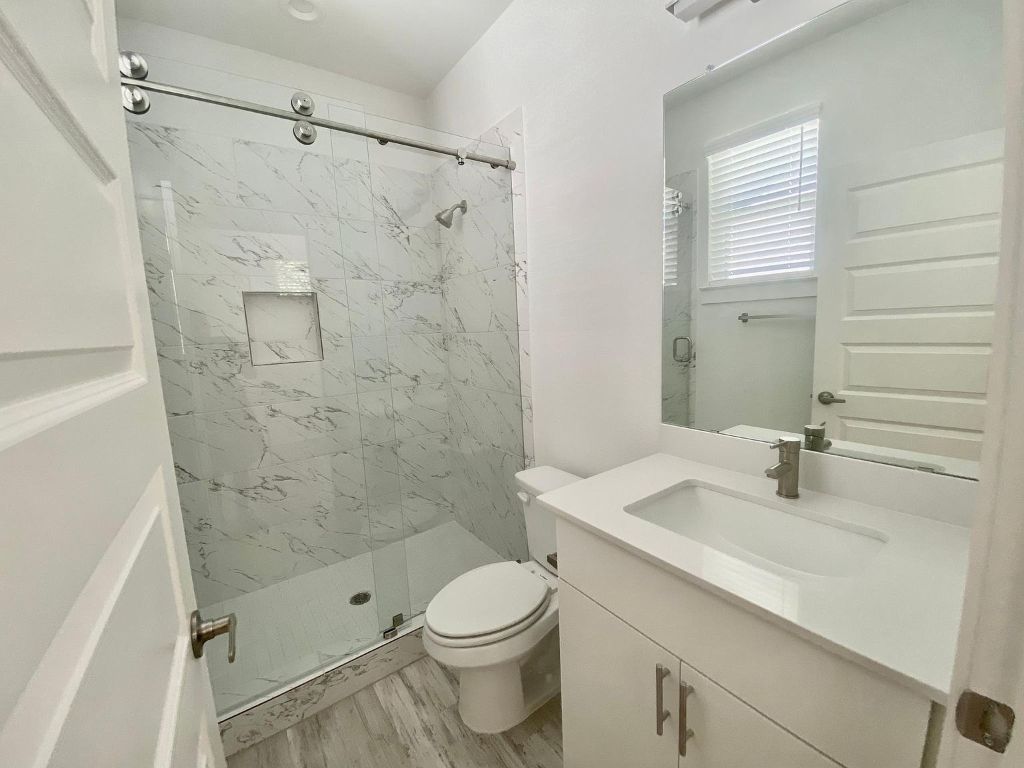 6809 Montana Street, Unit 2 Austin, TX 78741 - Photo 17 of 29 a bathroom with a sink a toilet and shower