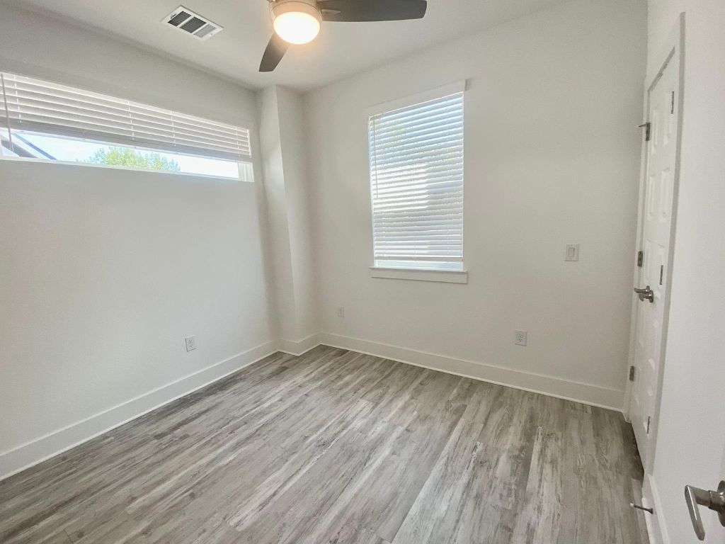 6809 Montana Street, Unit 2 Austin, TX 78741 - Photo 20 of 29 a view of an empty room with wooden floor and a window