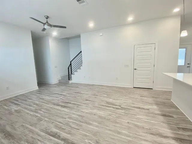 a view of an empty room with cabinet and a window