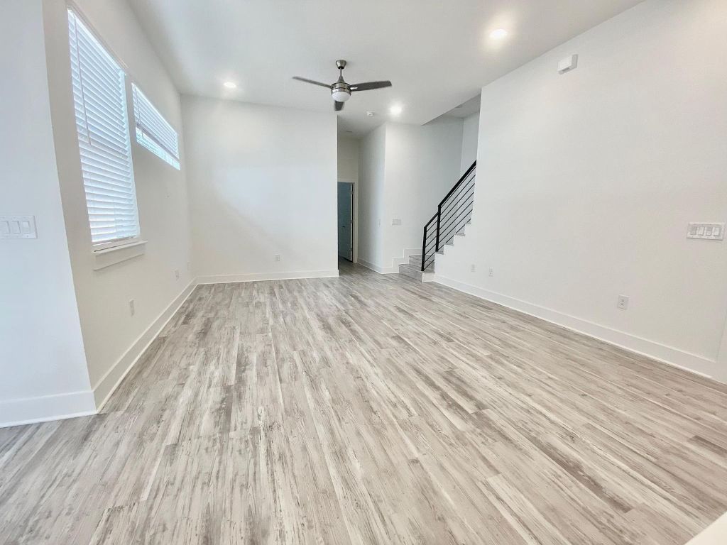 6809 Montana Street, Unit 2 Austin, TX 78741 - Photo 5 of 29 wooden floor in an empty room with a window