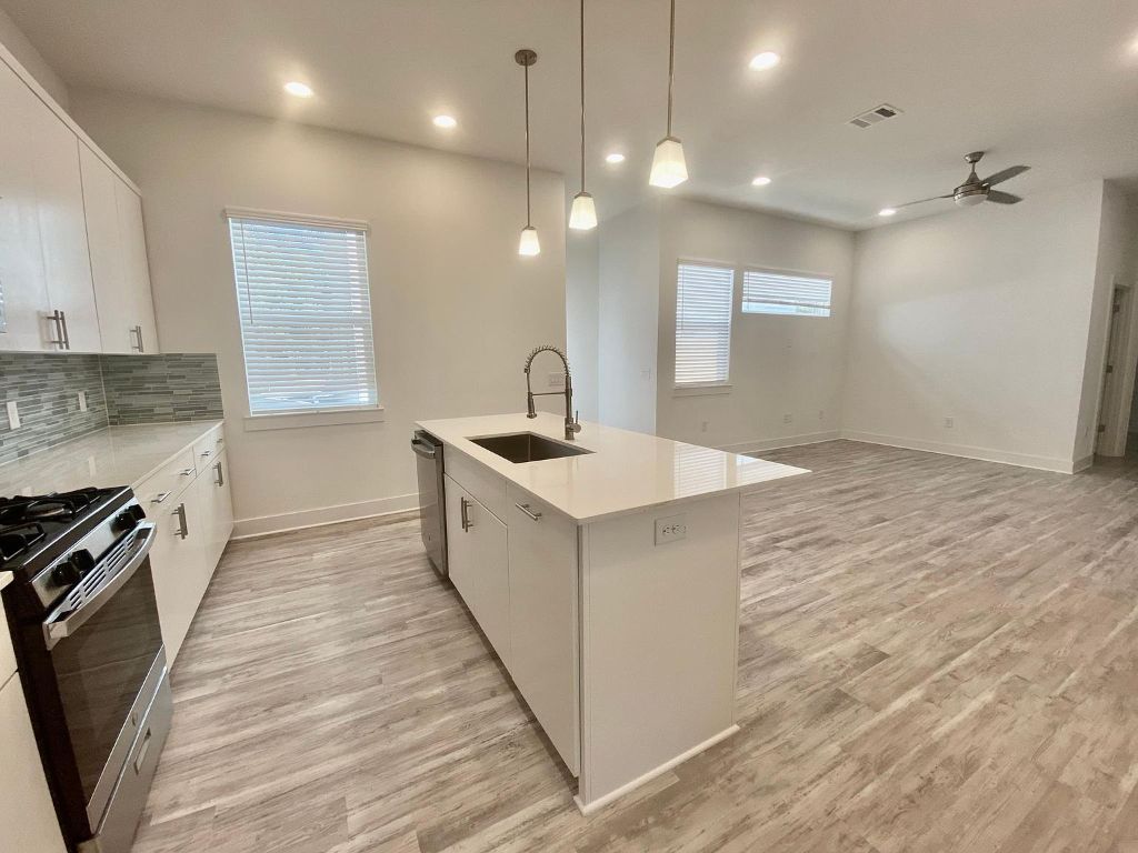 6809 Montana Street, Unit 2 Austin, TX 78741 - Photo 6 of 29 a kitchen with a sink stove and cabinets