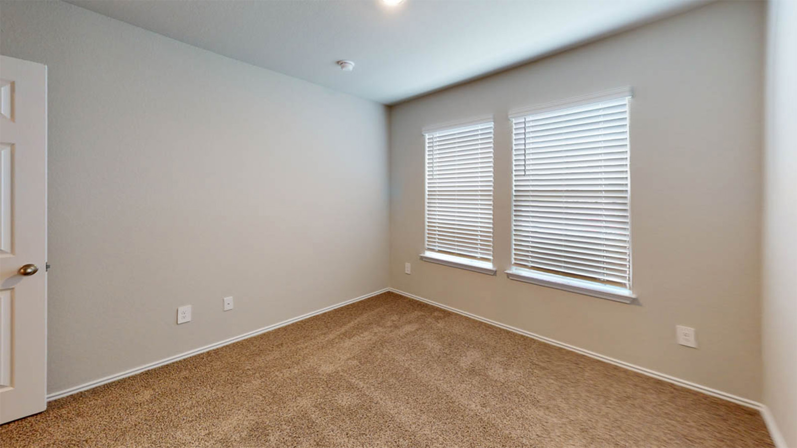 1417 Victory Rnch Trail Killeen, TX 76549 - Photo 16 of 22 A quiet, carpeted room awaits personalization, illuminated by natural light filtering through dual windows.