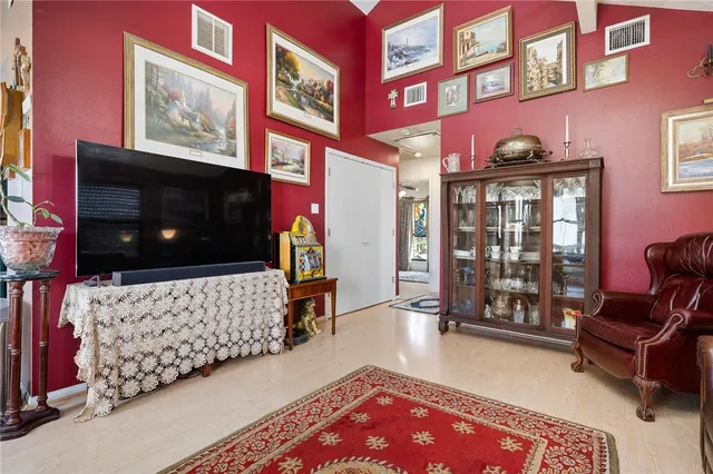 a living room with furniture rug and flat screen tv