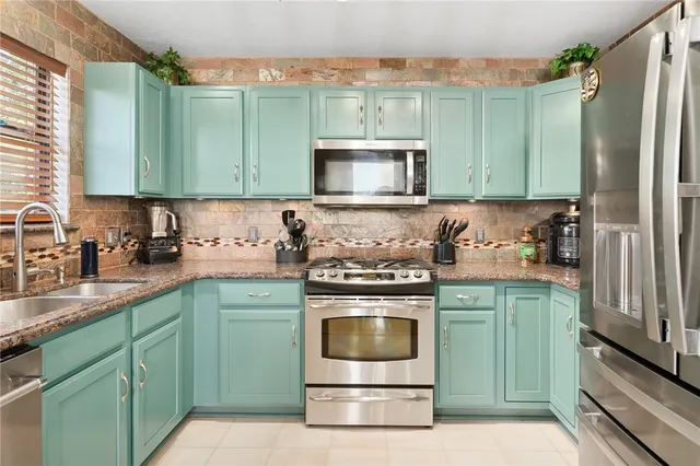 a kitchen with cabinets a sink and a stove