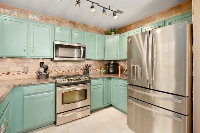 a kitchen with a refrigerator sink and microwave