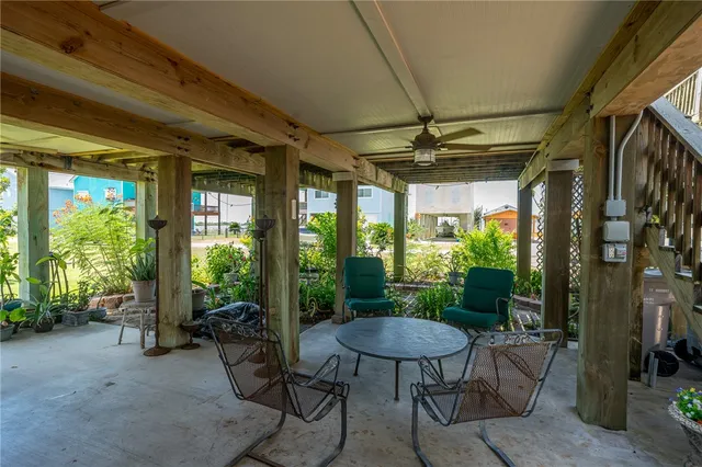 a view of an outdoor dining space with a table and chairs
