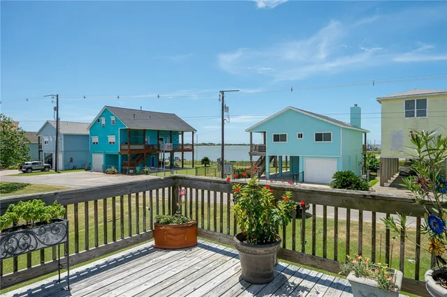 a view of a house with wooden fence and a floor to ceiling window
