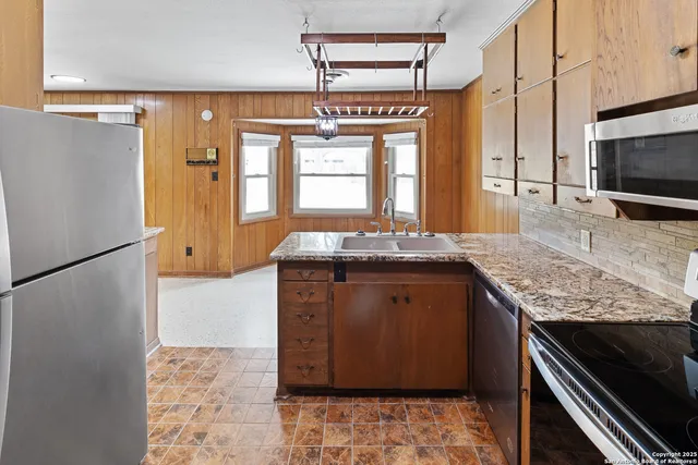 a kitchen with a refrigerator and a sink