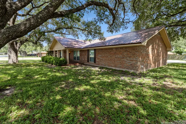 a view of a house with a yard and tree s