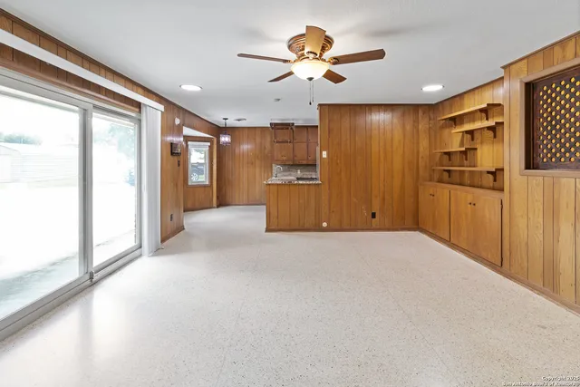 a kitchen with stainless steel appliances granite countertop a refrigerator a stove and a sink