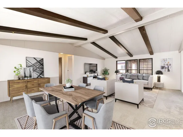 a living room with furniture and next to a window