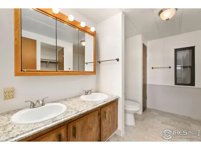 a bathroom with a granite countertop sink mirror and double