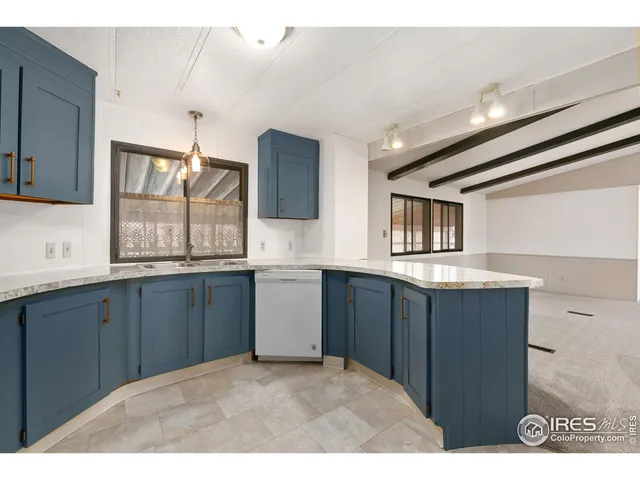 a kitchen with granite countertop cabinets and window