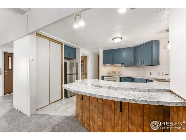 a kitchen with stainless steel appliances granite countertop a sink refrigerator and cabinets