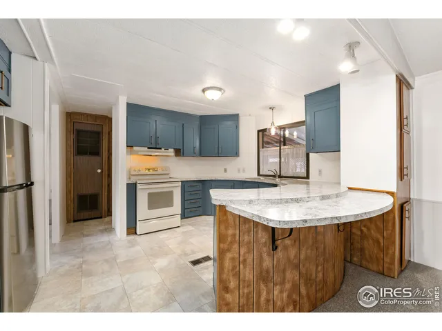 a kitchen with stainless steel appliances granite countertop a sink a stove and a refrigerator
