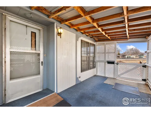 a view of kitchen with furniture and refrigerator
