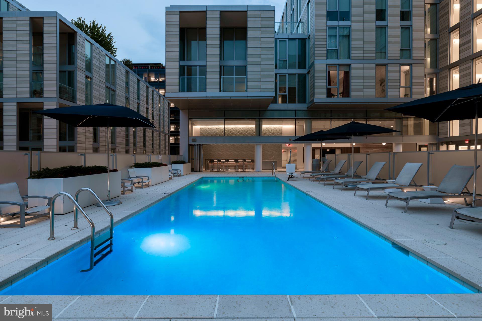 920 I Street Northwest, Unit 704 Washington, DC 20001 - Photo 15 of 24 a swimming pool with outdoor seating and yard