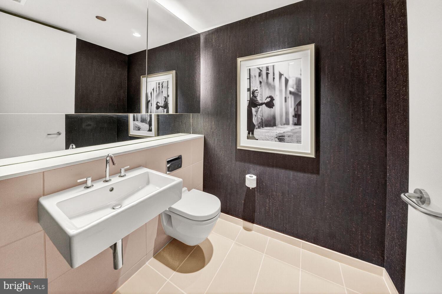 920 I Street Northwest, Unit 704 Washington, DC 20001 - Photo 7 of 24 a bathroom with a sink and a mirror