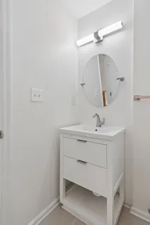 a bathroom with a sink a mirror and vanity