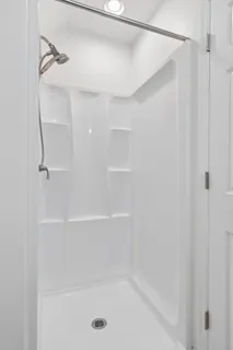 a bathroom with a shower and a shower head