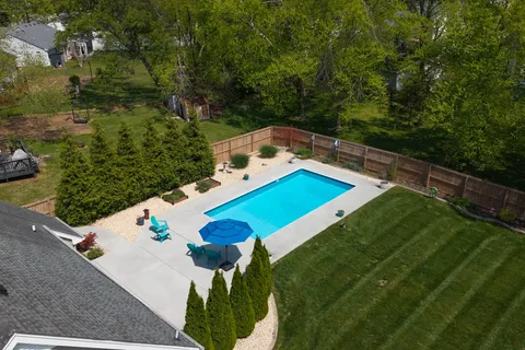 an aerial view of a house with a yard