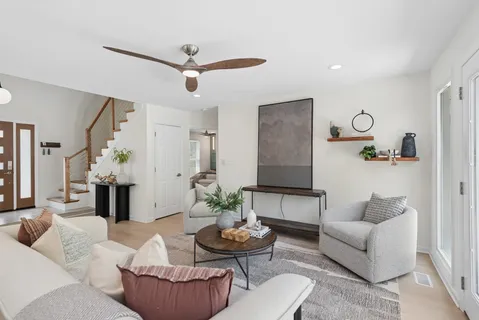 a living room with furniture and a chandelier