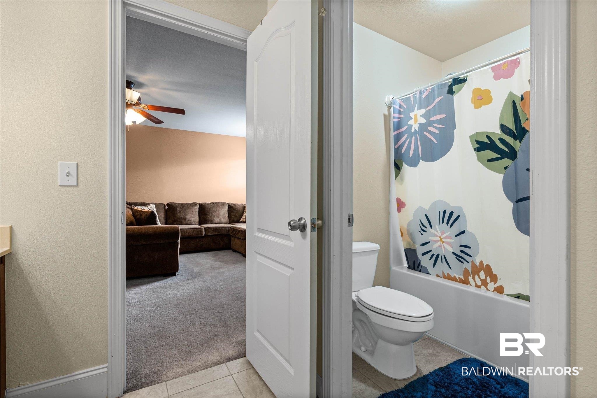 585 Sheffield Avenue Foley, AL 36535 - Photo 43 of 45 Bathroom featuring a white toilet, bathtub with shower, and tile flooring
