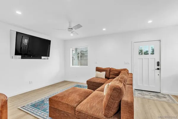 a bedroom with furniture and a flat screen tv