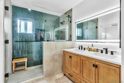 a bathroom with a shower sink and mirror