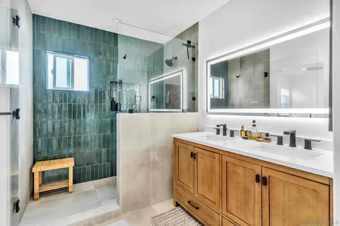 a bathroom with a shower sink and mirror