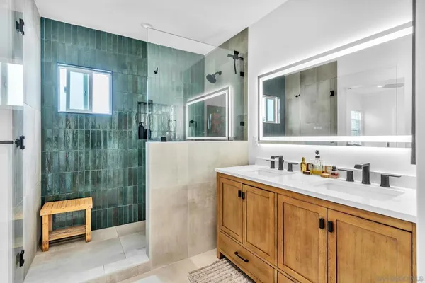 a bathroom with a shower sink and mirror