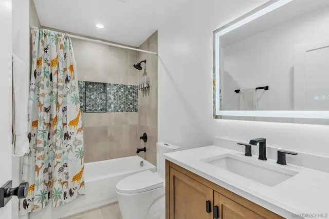 a bathroom with a sink toilet and shower