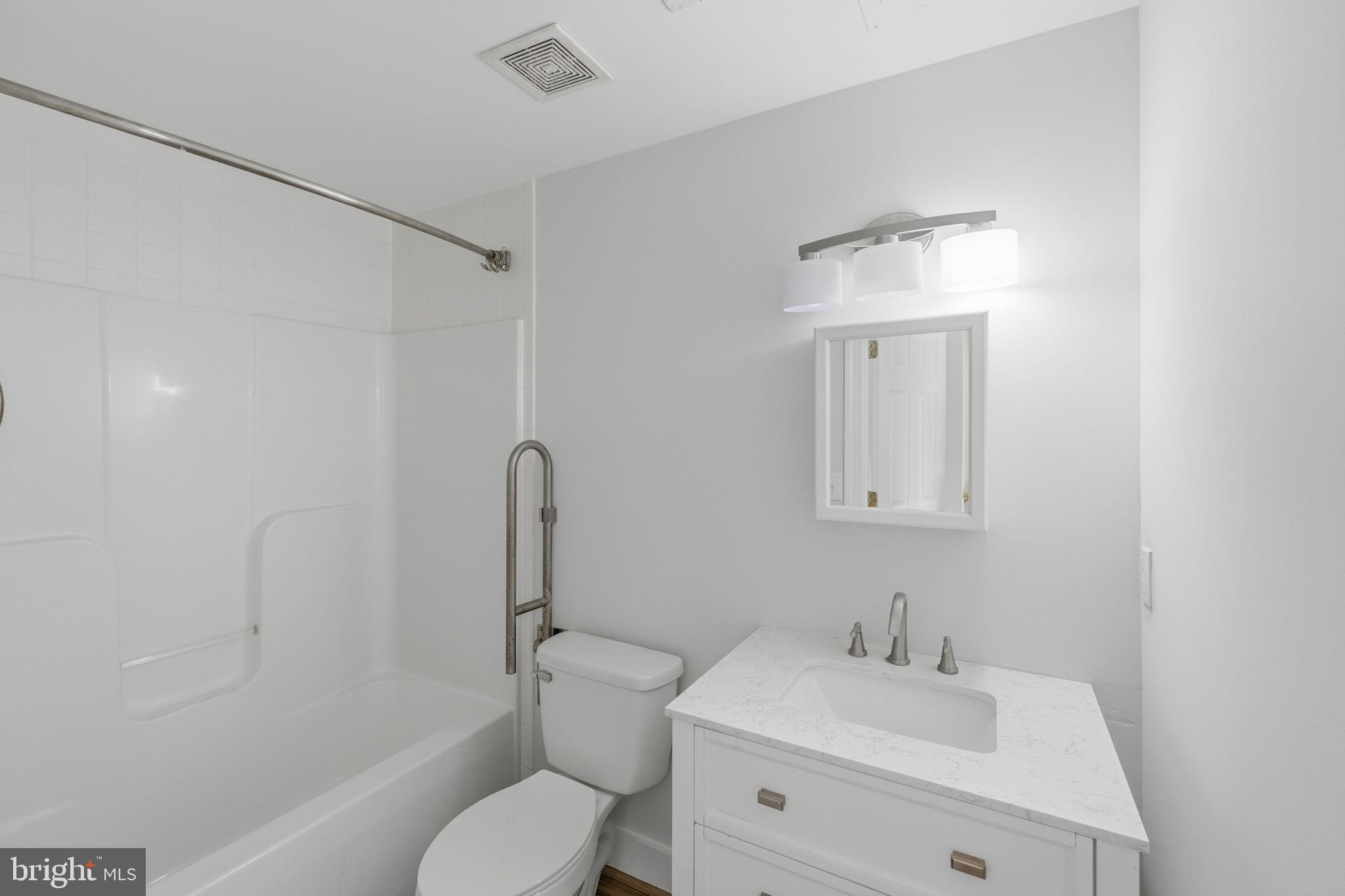 7522 Stubbs Bridge Road Spotsylvania, VA 22551 - Photo 33 of 60 a bathroom with a sink toilet vanity and shower