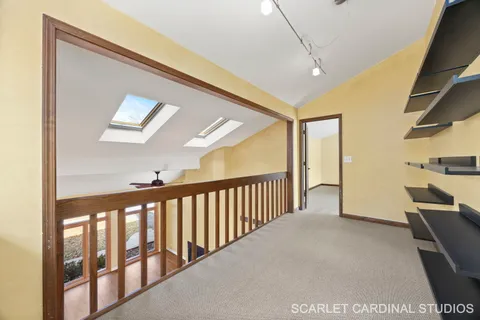 a view of a hallway with seating area