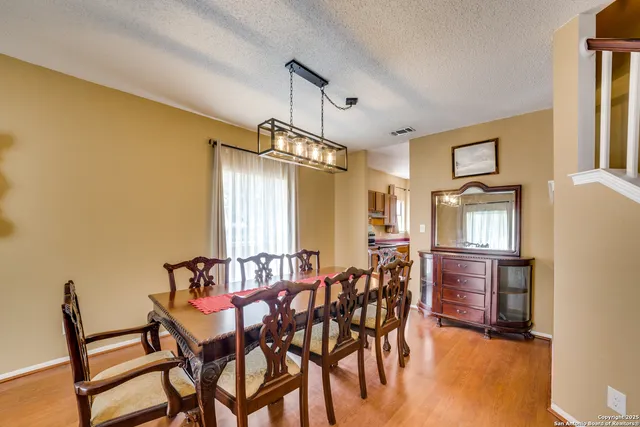 a dining room with furniture and window