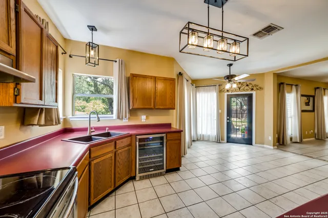 a kitchen with stainless steel appliances a sink stove and cabinets