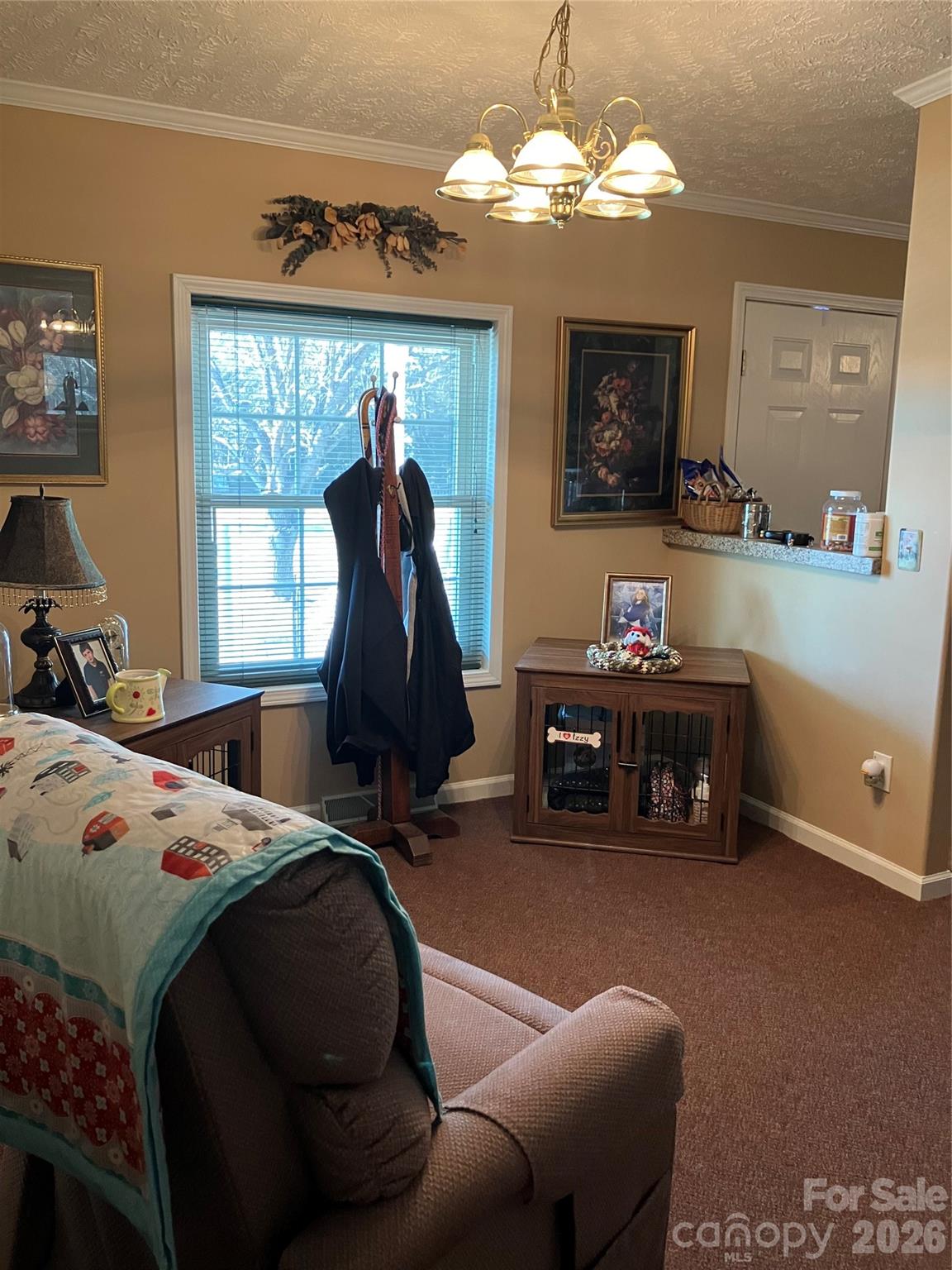 13215 Pine Bluff Road Midland, NC 28107 - Photo 23 of 48 a bedroom with bed and a chandelier