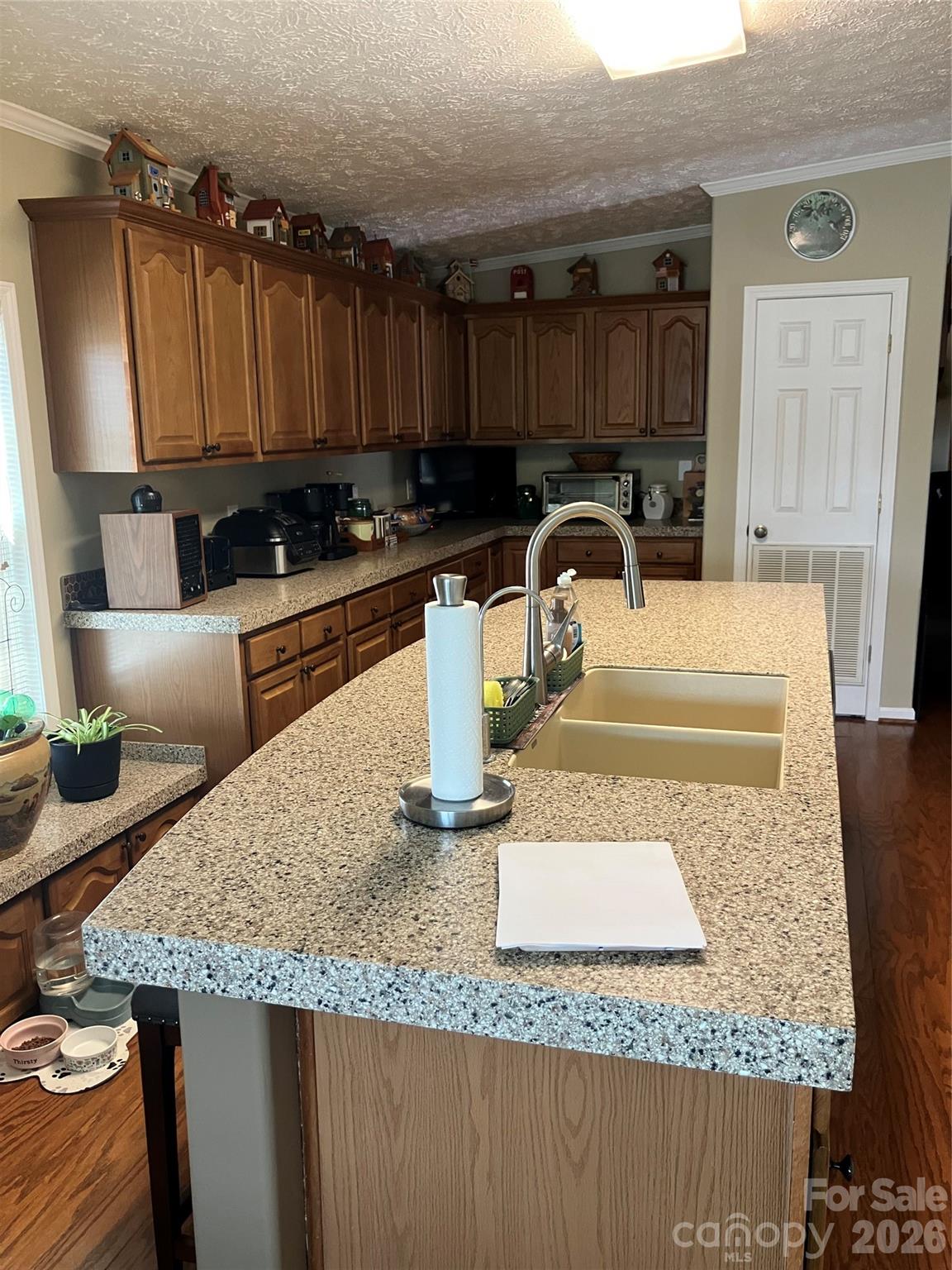 13215 Pine Bluff Road Midland, NC 28107 - Photo 27 of 48 a kitchen with granite countertop a sink a stove and a wooden cabinets