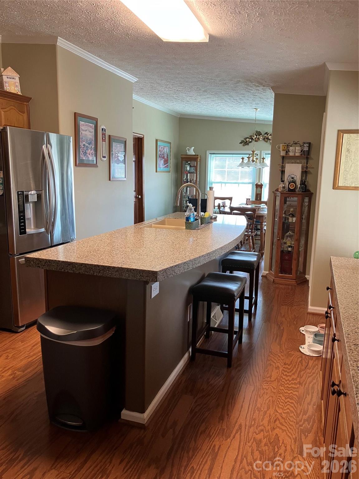 13215 Pine Bluff Road Midland, NC 28107 - Photo 28 of 48 a kitchen with a table chairs and refrigerator