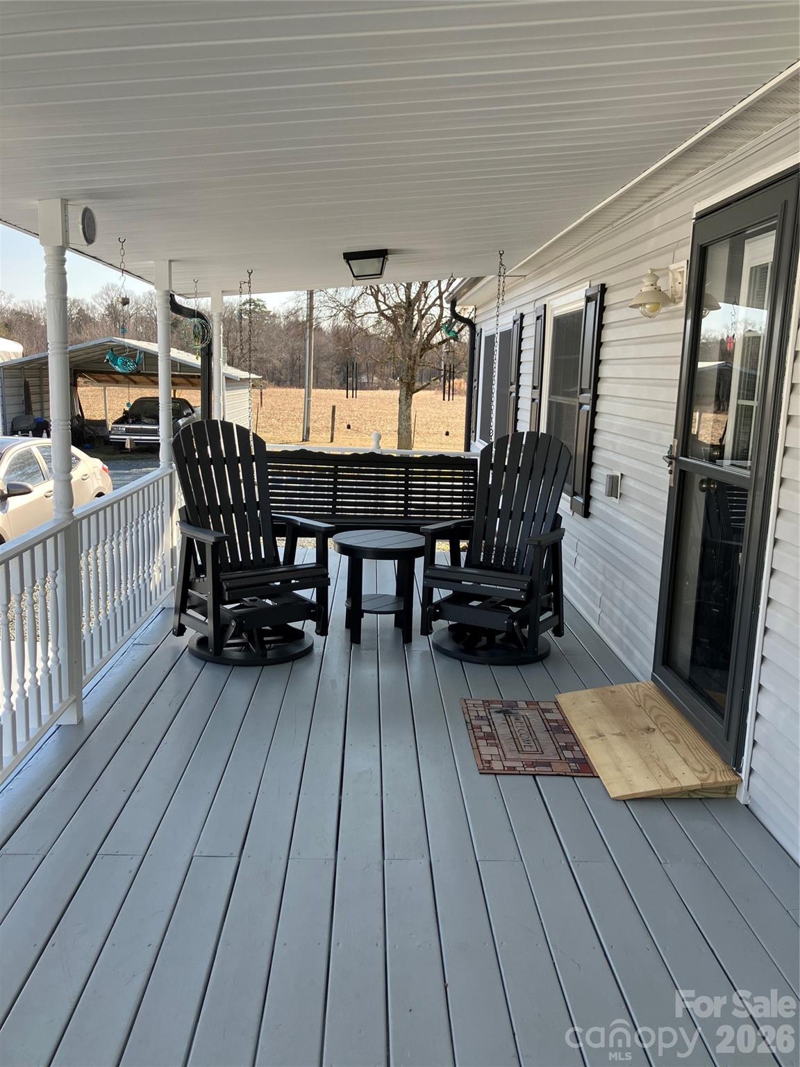 13215 Pine Bluff Road Midland, NC 28107 - Photo 6 of 48 a view of a roof deck with table and chairs