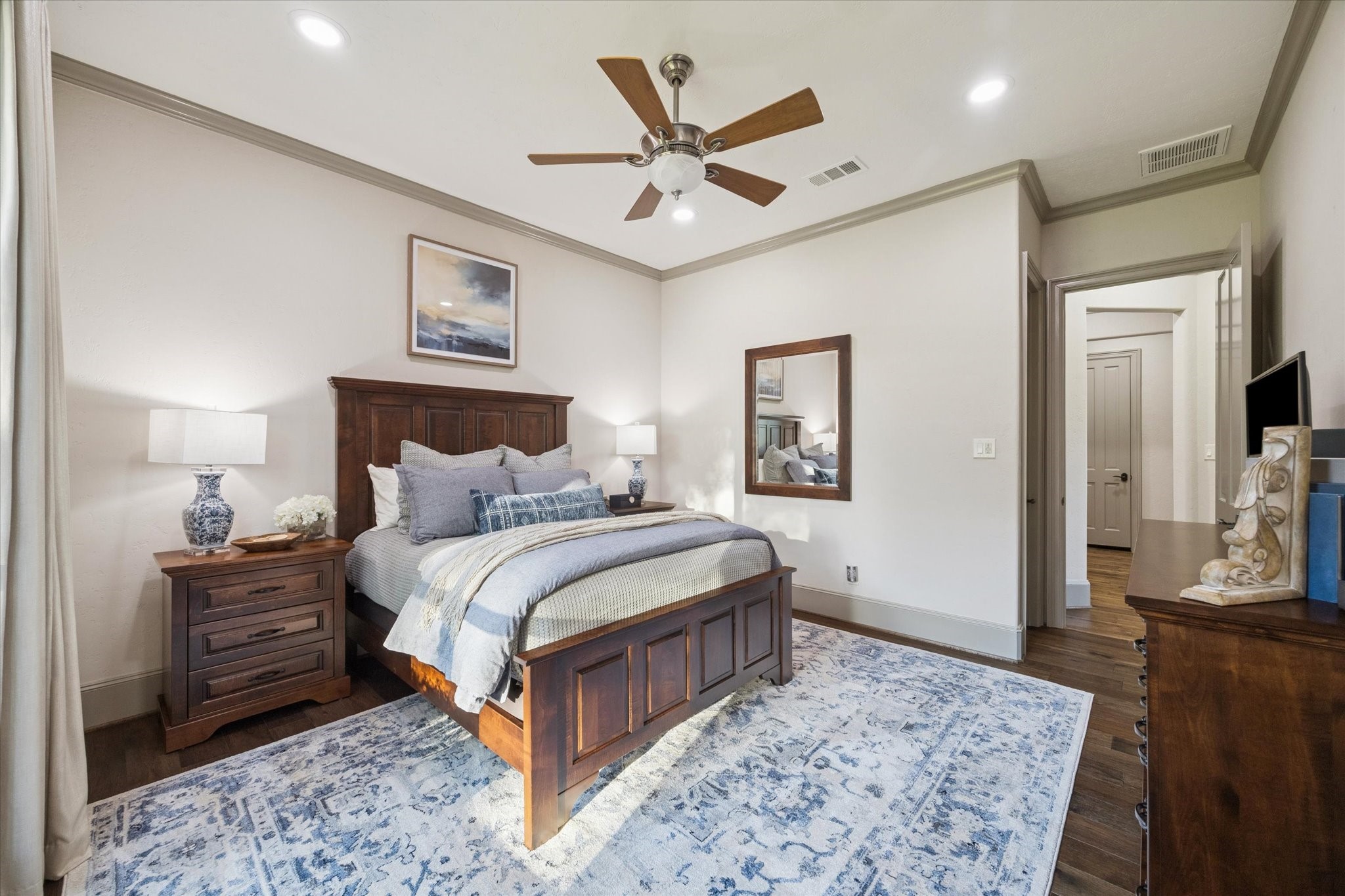 6602 Riva Ridge Drive Richmond, TX 77406 - Photo 41 of 50 a bedroom with a large bed and a chandelier