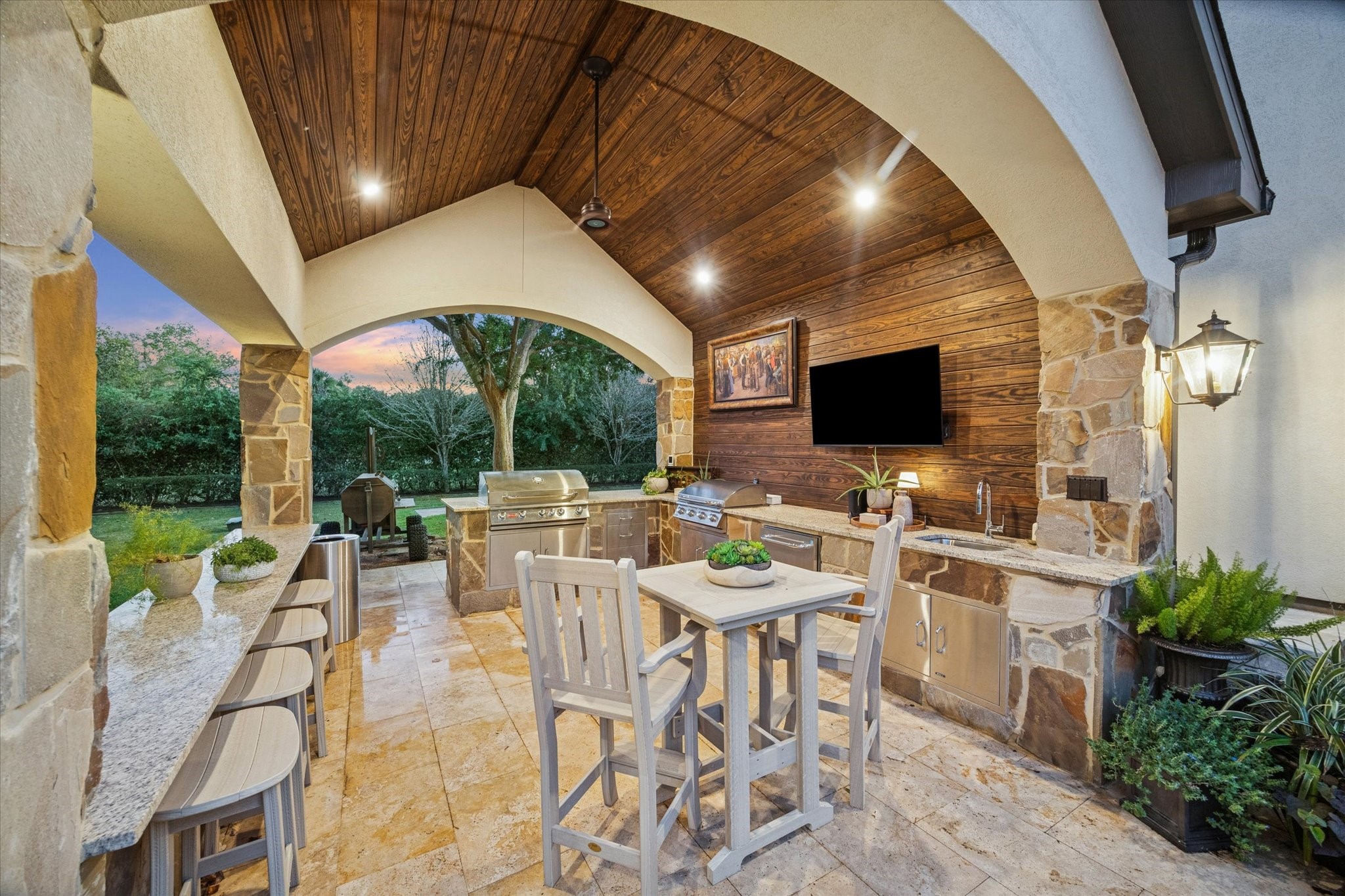 6602 Riva Ridge Drive Richmond, TX 77406 - Photo 8 of 50 a view of a patio with a dining table and chairs with a flat screen tv