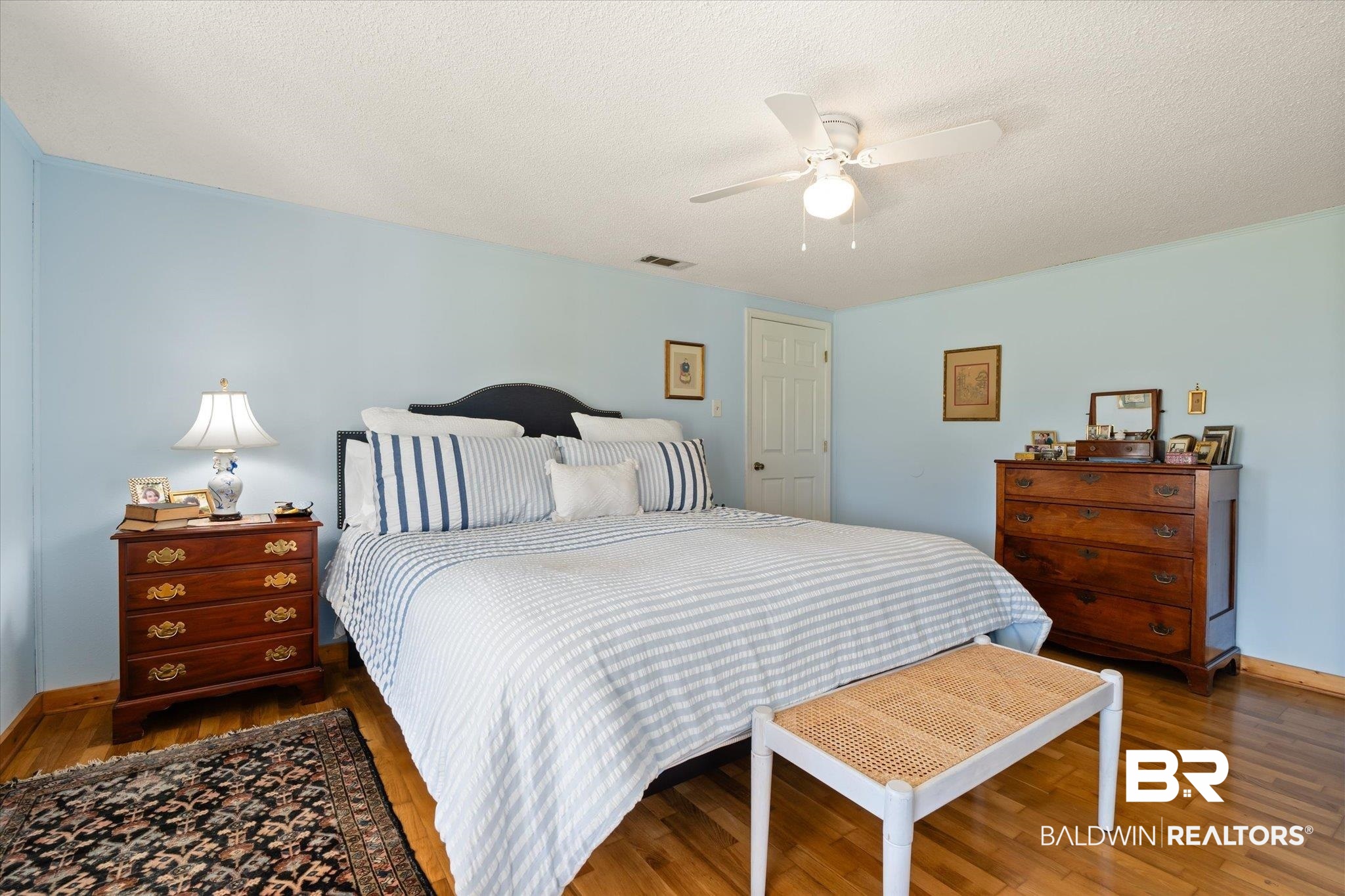 14280 Cat Deakle Road Grand Bay, AL 36541 - Photo 14 of 51 Bedroom with baseboards, visible vents, a ceiling fan, wood finished floors, and a textured ceiling