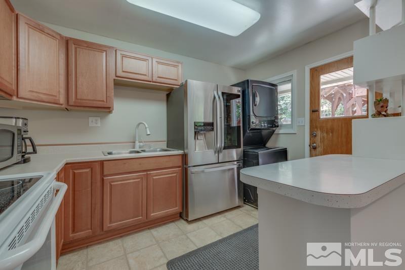 805 Reeves Avenue Reno, NV 89503 - Photo 8 of 21 a kitchen with stainless steel appliances granite countertop a sink stove and refrigerator