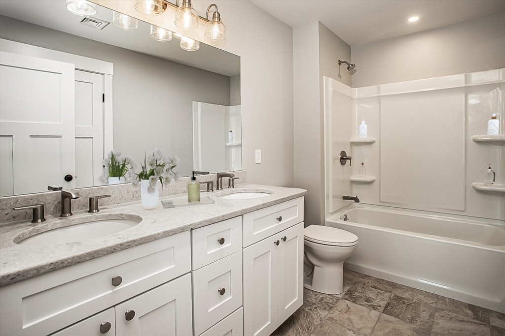 337 Danforth Street, Unit 7 Fall River, MA 02720 - Photo 20 of 28 a bathroom with a granite countertop toilet sink and a bathtub