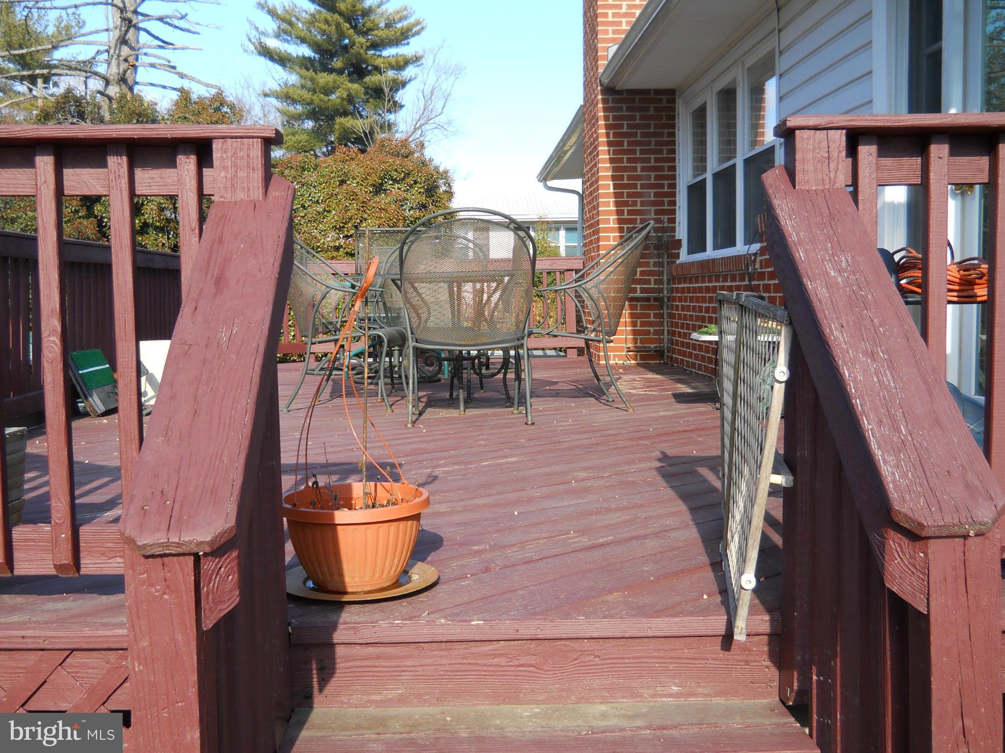 3604 Bellmore Road Baltimore, MD 21244 - Photo 16 of 19 a view of a patio with table and chairs potted plants with wooden floor