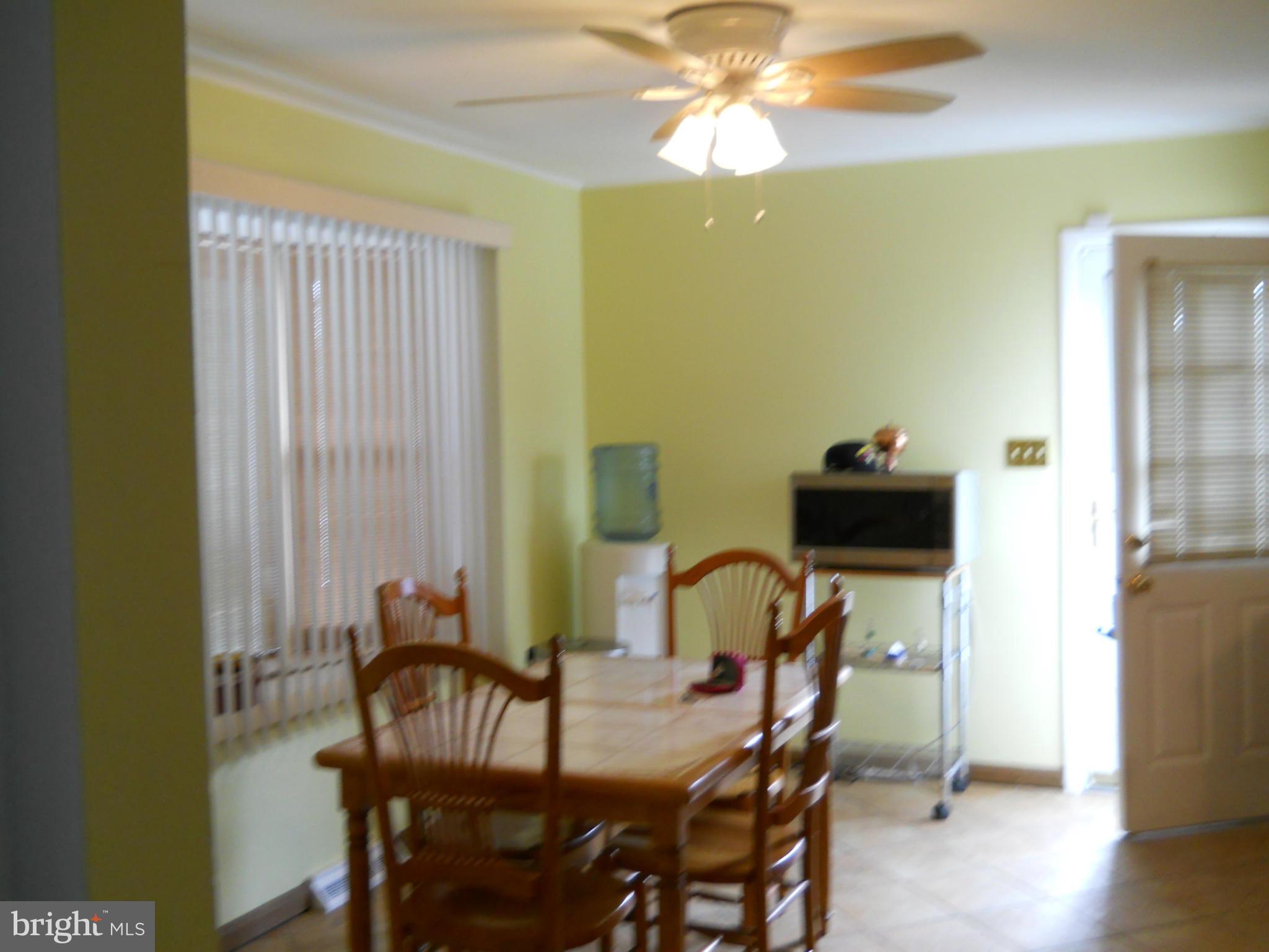3604 Bellmore Road Baltimore, MD 21244 - Photo 3 of 19 a view of a dining room with furniture and wooden floor
