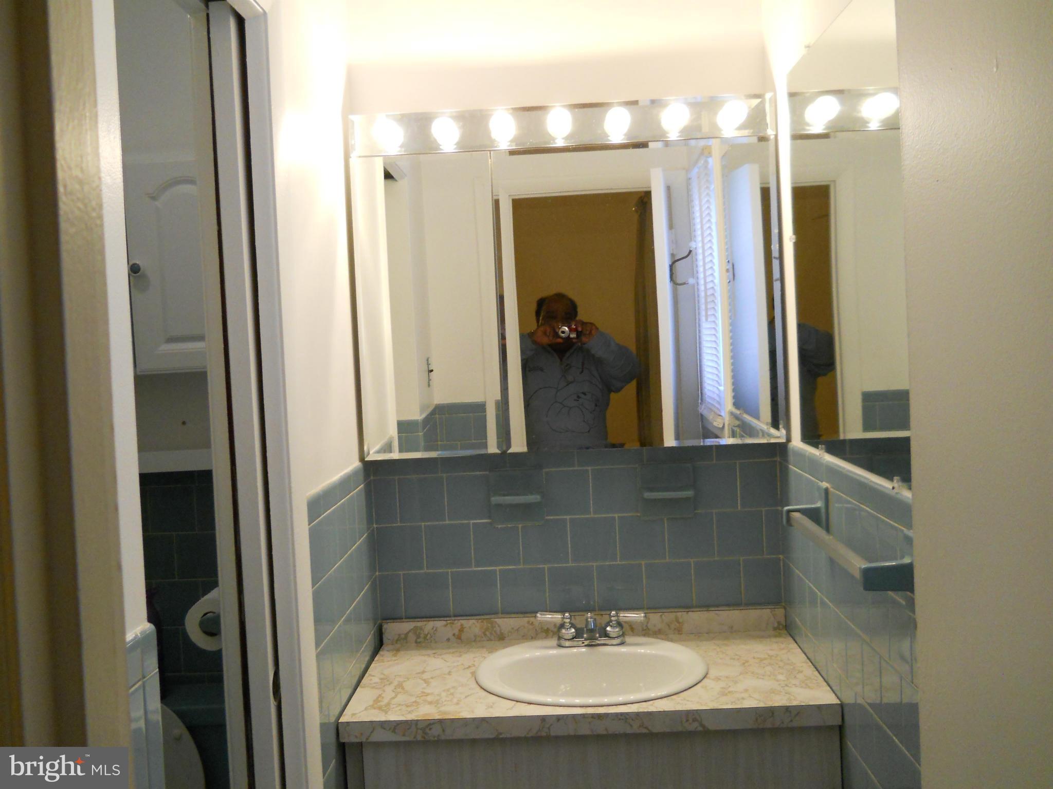 3604 Bellmore Road Baltimore, MD 21244 - Photo 8 of 19 a bathroom with a sink and a mirror